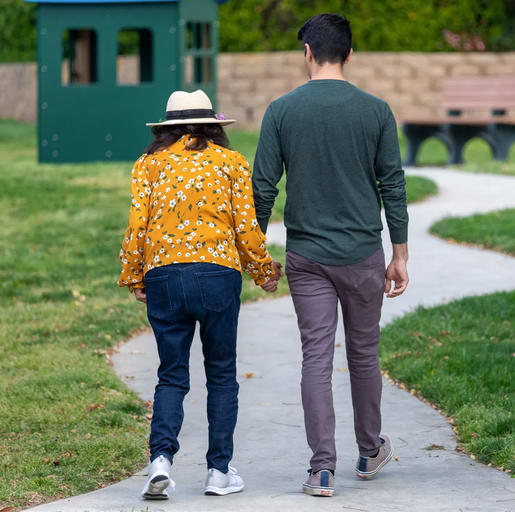 family members holding hands and walking