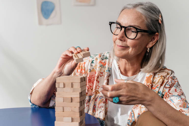 senior woman playing jenga